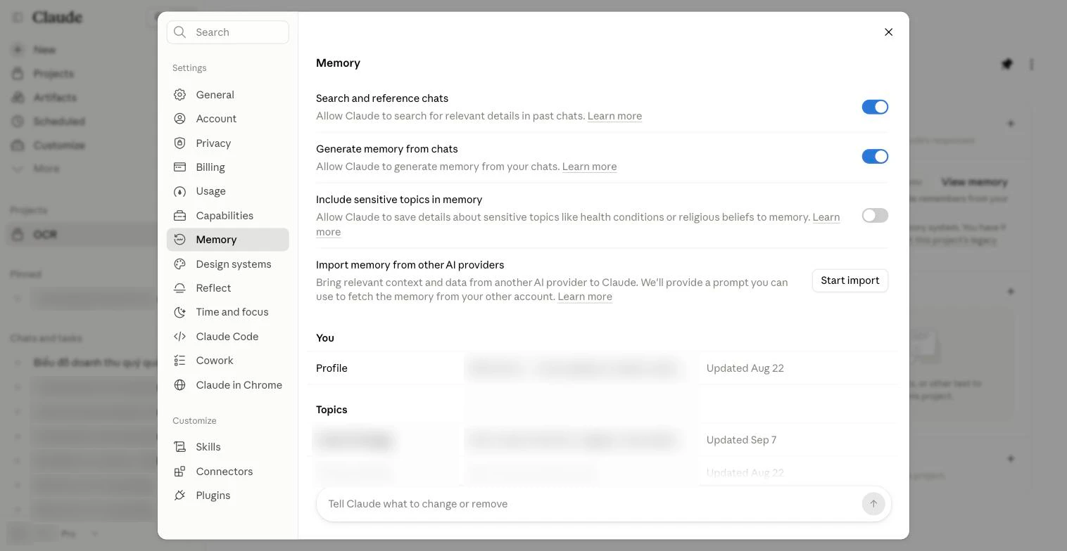 Trang Settings, mục Memory: các công tắc Search and reference chats, Generate memory from chats, Include sensitive topics in memory; nút Start import; danh sách Profile và Topics (đã làm mờ); ô nhập để bảo Claude sửa bộ nhớ.